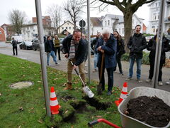 Zwei Personen heben eine kleine Grube aus